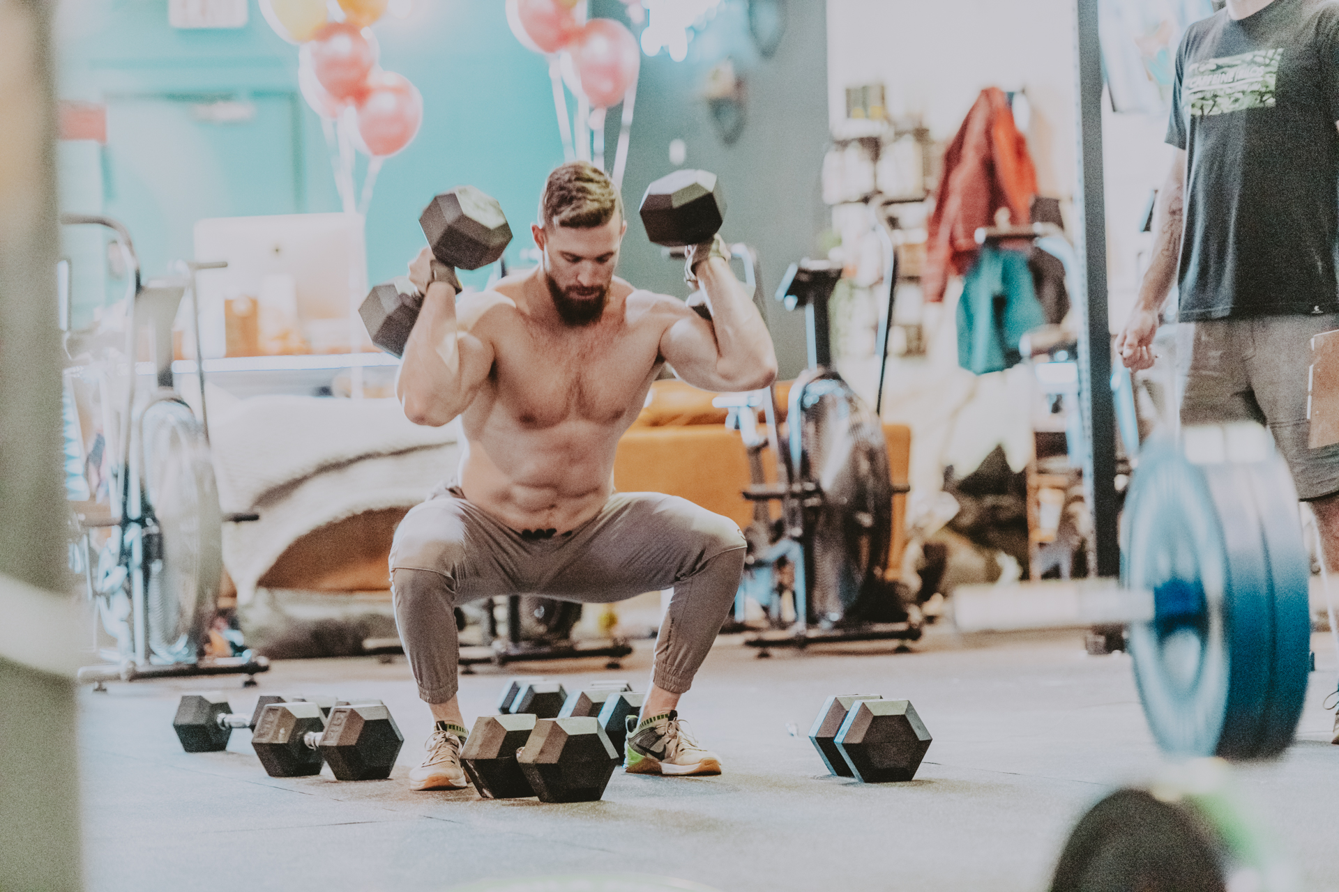 Shirtless man squatting in gym in Victoria BC Crossfit Gym 