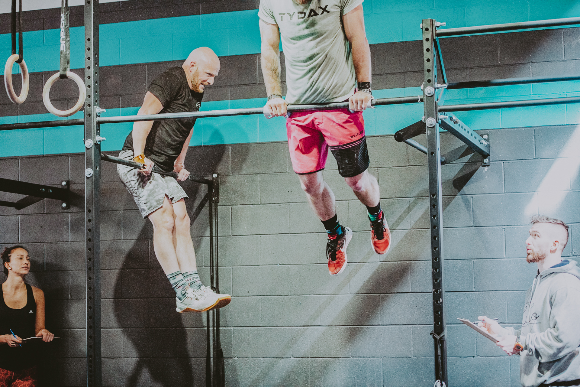Bros on bars doing muscle ups- Victoria BC Crossfit Gym 